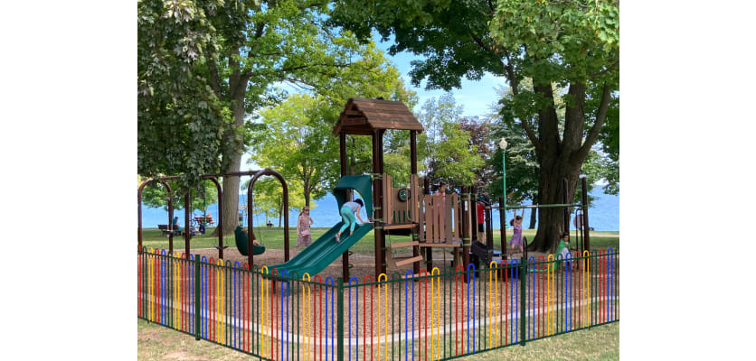 The 1.8m High EnviroRail Bow Top Play Sec Railings with a Multicoloured Finish surrounding a park
