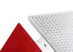 Close up of corner of red and white armco barrier reflector 