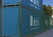 Green chain link fencing installed around warehouse