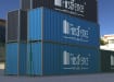 Green chain link fencing installed around storage containers 