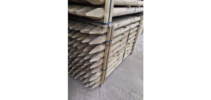 Tanalised timber posts stacked in storage