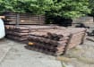 Creosote timber posts stacked in storage