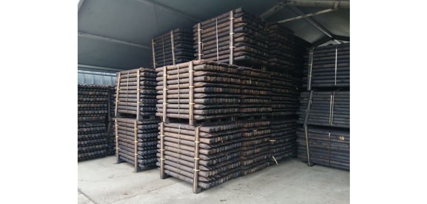 Creosote timber posts in storage