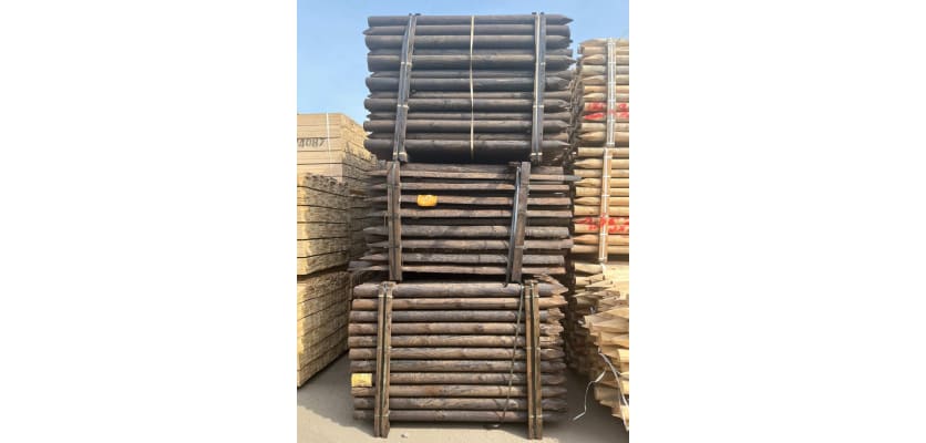 Creosote timber posts in storage