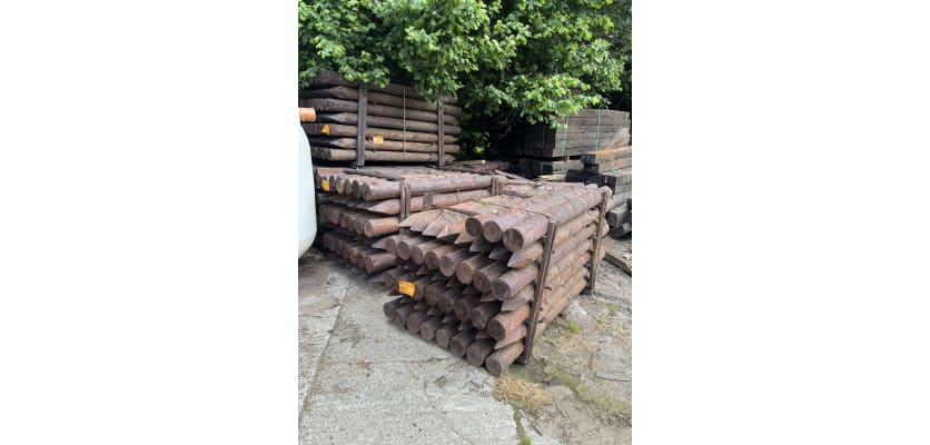 Creosoted timber fence posts