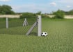 End concrete post with chain link fencing, installed on a football field, with a football next to the post