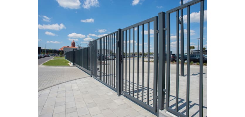 An FFL 60S Manual Vertical Bar Swing Gate outside of a car park