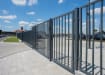 An FFL 60S Manual Vertical Bar Swing Gate outside of a car park