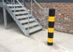 Black and yellow bollard installed near outdoor stairs