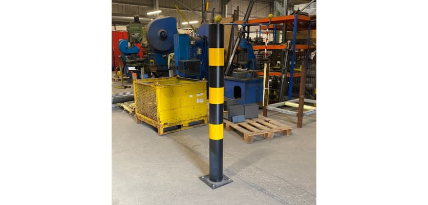 Plain Round Black & Yellow Bollard installed in warehouse