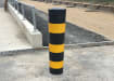 Round black and yellow dig in bollard designed for outdoor use