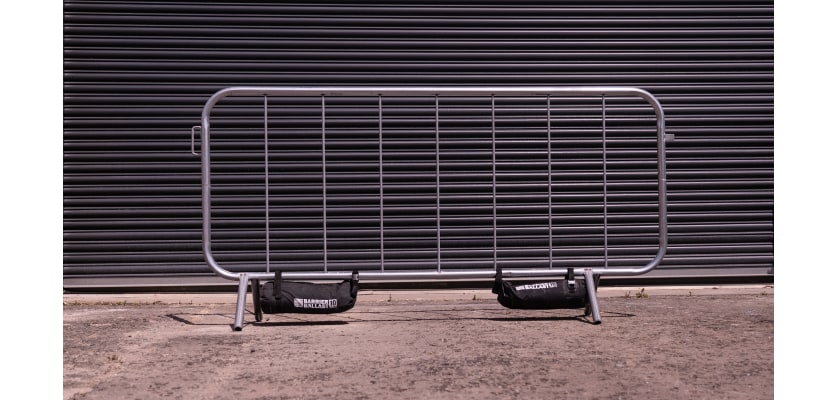 Standard crowd control barrier with two ballast bags attached
