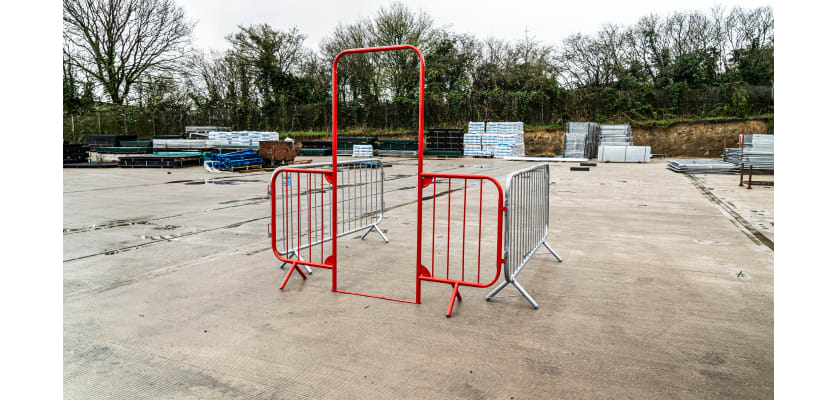 Red Walk through barrier attached to crowd control barriers
