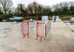 Red Walk through barrier attached to crowd control barriers