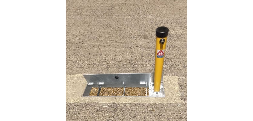 Hinged stealth parking post installed in a ground socket, standing 580mm above ground, designed for optimal visibility and security.