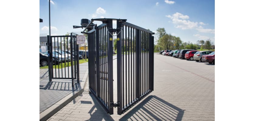 A Black FFL RapidFold Single Leaf Bifold Gate in a Car Park