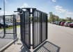 A Black FFL RapidFold Single Leaf Bifold Gate in a Car Park