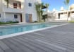Bambura® Wood Plastic Composite Essential Deck Trim - Grey installed around the pool 