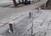 Three Stainless Steel Automatic Telescopic Hydraulic Bollard Kit installed on pavement