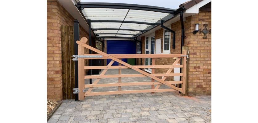 A 1.2m High Meranit Hardwood Ranch Gate installed in a courtyard