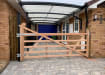A 1.2m High Meranit Hardwood Ranch Gate installed in a courtyard