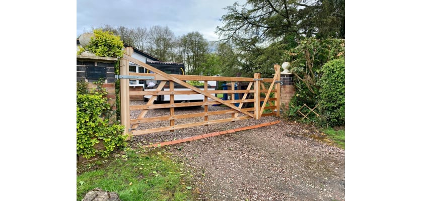 A 1.2m high Iroko Hardwood Timber Ranch Gate installed on a rural driveway