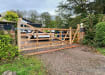 A 1.2m high Iroko Hardwood Timber Ranch Gate installed on a rural driveway