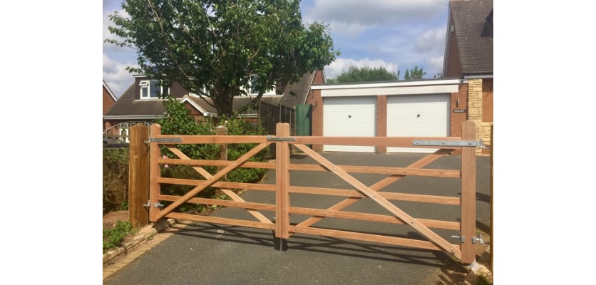 A 1.2m High Meranti Hardwood Timber Field Gate installed on a Drive