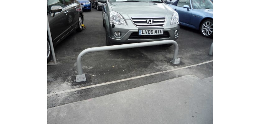 Removable hooped barrier installed in a car park
