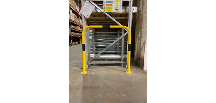 Black and yellow hooped barrier installed in a warehouse