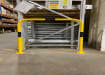 Black and yellow hooped barrier installed in a warehouse