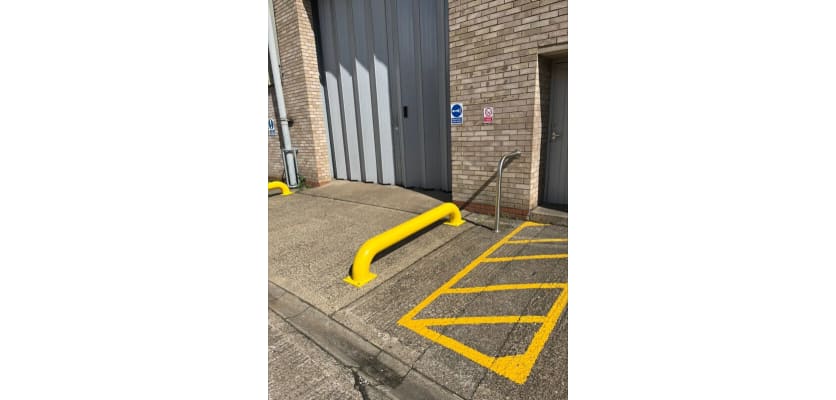 Yellow Galvanised Steel Wheel Guide Bolt Down installed outside warehouse