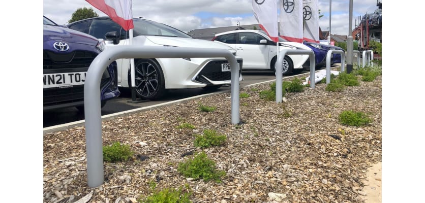 Hooped barriers installed in an outdoor car dealer