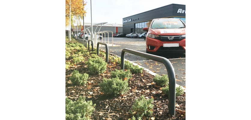 Hooped barriers installed in an outdoor car dealer