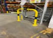 Black and yellow hooped barrier installed in a warehouse