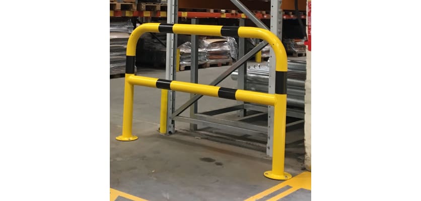 Black and yellow hooped safety barrier installed in a warehouse