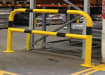 Black and yellow hooped safety barrier installed in a warehouse