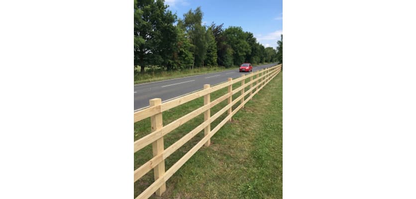 4 rail post and rail fence installed roadside 
