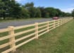 4 rail post and rail fence installed roadside 