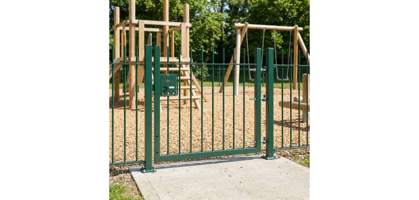 Green vertical railing gate installed around park 
