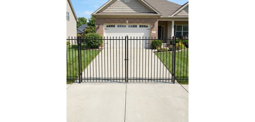 OldStead Welded Residential 2 Rail Spear Top Drive Gate installed in front of large property 