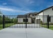 OldStead Welded Residential 3 Rail Flat Top Drive Gate installed in front of residential property