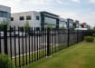 OldStead Welded Commercial 70" 2 Rail Spear Top Fencing installed in parking lot