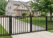 A black Aluminum Residential 2-Rail Flat Top Drive Gate leaf pair shown with heavy-duty mounting hinges and a center latch.
