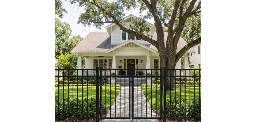 A 3-rail flat top black Aluminum Driveway Gate pair installed at the front of a residential property.