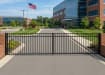 Black Aluminum Commercial Driveway Gate pair with a 3-rail design and a safe flat top rail, installed at a commercial building entrance to provide secure access.