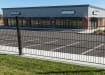 Mesh fencing with bolt-down posts, installed outside a commercial property