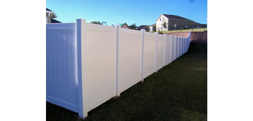 White vinyl fencing installed around a property boarder