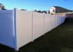 White vinyl fencing installed around a property boarder