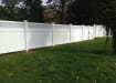 White vinyl fencing installed around a yard property line